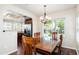 Charming dining room with wood table, chandelier, and view into the kitchen at 9450 E Becker Ln # 1071, Scottsdale, AZ 85260