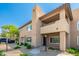 Inviting two-story condo featuring a well-maintained landscape, walkway, and private balcony space at 9450 E Becker Ln # 1071, Scottsdale, AZ 85260