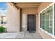 Exterior front door entrance, featuring a stylish black door with side windows and accent plants at 9450 E Becker Ln # 1071, Scottsdale, AZ 85260