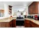 Well-maintained kitchen with stainless steel appliances, granite countertops, and wood cabinets at 9450 E Becker Ln # 1071, Scottsdale, AZ 85260