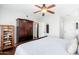 Cozy main bedroom featuring a ceiling fan, armoire, and warm decor at 9450 E Becker Ln # 1071, Scottsdale, AZ 85260