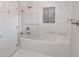 Clean bathroom featuring a modern bathtub with glass screen, tile, and new fixtures at 9551 E Redfield Rd # 1061, Scottsdale, AZ 85260