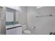 Bathroom with a modern sink vanity, mosaic backsplash, and toilet with stylish towel bar and paper holder at 9551 E Redfield Rd # 1061, Scottsdale, AZ 85260