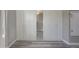 Bedroom with a view of a mirror, white cabinets, and wood-look floors at 9551 E Redfield Rd # 1061, Scottsdale, AZ 85260
