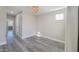 Empty bedroom with wood-look flooring, a window, and a chandelier at 9551 E Redfield Rd # 1061, Scottsdale, AZ 85260