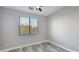 Bright bedroom with modern ceiling fan, wood-look floors, neutral walls, and window with backyard views at 9551 E Redfield Rd # 1061, Scottsdale, AZ 85260