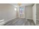 Spacious bedroom with wood-look flooring, a window, and a chandelier at 9551 E Redfield Rd # 1061, Scottsdale, AZ 85260