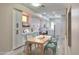 Bright dining room showcasing modern white cabinets, a wood table and neutral flooring at 9551 E Redfield Rd # 1061, Scottsdale, AZ 85260