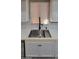 Close-up of kitchen sink featuring stainless steel basin, modern faucet and white cabinets at 9551 E Redfield Rd # 1061, Scottsdale, AZ 85260