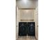 Laundry room with a pair of front loading washing machines and overhead cabinets for storage at 9551 E Redfield Rd # 1061, Scottsdale, AZ 85260