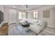 Bright and modern living room with gray floors, a large sofa, and an area rug at 9551 E Redfield Rd # 1061, Scottsdale, AZ 85260