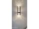 Interior view of modern wall sconce with bubble accents and textured wall in a neutral color at 9551 E Redfield Rd # 1061, Scottsdale, AZ 85260