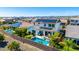Spacious backyard with a sparkling pool, well-manicured lawn, and solar panels for energy efficiency at 9677 W Patrick Ln, Peoria, AZ 85383