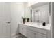 Bright bathroom features a large mirror, white cabinets, and stylish tile flooring at 9677 W Patrick Ln, Peoria, AZ 85383