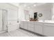 Elegant bathroom with a soaking tub, glass shower, double vanity, and patterned tile flooring at 9677 W Patrick Ln, Peoria, AZ 85383