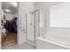 Bright bathroom offers a glass shower, soaking tub, and a spacious walk-in closet at 9677 W Patrick Ln, Peoria, AZ 85383
