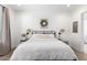 Cozy bedroom features neutral decor, soft lighting, and a decorative wreath hanging over the bed at 9677 W Patrick Ln, Peoria, AZ 85383