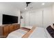 A bedroom features wood floors, a ceiling fan, and a wooden dresser at 9677 W Patrick Ln, Peoria, AZ 85383