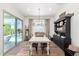 Elegant dining room featuring a large table, chandelier lighting, and access to the pool area at 9677 W Patrick Ln, Peoria, AZ 85383