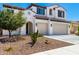 Lovely two-story home with a terracotta-tiled roof, a two-car garage, and desert landscaping at 9677 W Patrick Ln, Peoria, AZ 85383