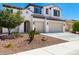 A two-story house with a three car garage and xeriscaped front yard at 9677 W Patrick Ln, Peoria, AZ 85383