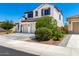 A two-story house with a three car garage and landscaped front yard at 9677 W Patrick Ln, Peoria, AZ 85383