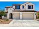 A charming two-story home boasting a neutral color scheme and a three-car garage, framed by manicured landscaping at 9677 W Patrick Ln, Peoria, AZ 85383