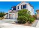 A two-story house with a three car garage and landscaped front yard at 9677 W Patrick Ln, Peoria, AZ 85383
