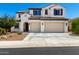 Charming two-story home featuring a tile roof, light-colored stucco, and a spacious two-car garage at 9677 W Patrick Ln, Peoria, AZ 85383