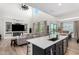 Modern kitchen overlooking the living room, featuring sleek countertops and stainless steel appliances at 9677 W Patrick Ln, Peoria, AZ 85383