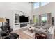 Bright living room with hardwood floors, a built-in entertainment center, and large windows at 9677 W Patrick Ln, Peoria, AZ 85383