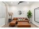 Cozy living room showcasing a stylish leather sectional, modern decor, and natural light at 9677 W Patrick Ln, Peoria, AZ 85383