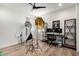 This office features a ceiling fan, wood floors, and photography equipment at 9677 W Patrick Ln, Peoria, AZ 85383