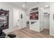 A home office features wood floors, white walls, and multiple doors at 9677 W Patrick Ln, Peoria, AZ 85383