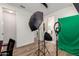 An office features a ceiling fan, wood floors, and photography equipment at 9677 W Patrick Ln, Peoria, AZ 85383