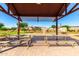 Community park with covered picnic tables and a view of play structures at 9677 W Patrick Ln, Peoria, AZ 85383