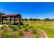 Community park featuring a picnic shelter with tables and expansive green space at 9677 W Patrick Ln, Peoria, AZ 85383