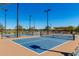 Brightly lit pickleball court featuring blue playing surface and well-maintained nets at 9677 W Patrick Ln, Peoria, AZ 85383