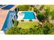 Aerial view of a backyard featuring a well maintained pool, a patch of lawn and lush landscaping at 9677 W Patrick Ln, Peoria, AZ 85383