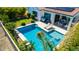 Aerial shot of a backyard oasis featuring a pool, lounge area, and lush tropical landscaping at 9677 W Patrick Ln, Peoria, AZ 85383