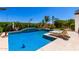 Sparkling pool with tanning deck and palm trees, perfect for relaxation and entertainment at 9677 W Patrick Ln, Peoria, AZ 85383