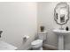 Well-lit powder room boasts a pedestal sink, decorative mirror, and neutral decor at 9677 W Patrick Ln, Peoria, AZ 85383