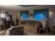 Spacious basement features a comfortable sofa with accent pillows and two windows at 103 S 75Th Pl, Mesa, AZ 85208