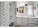 Clean and tidy bathroom with a shower-tub combo, vanity, and updated fixtures at 103 S 75Th Pl, Mesa, AZ 85208