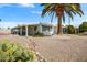 Charming home exterior featuring xeriscape landscaping and a covered patio in a sunny location at 103 S 75Th Pl, Mesa, AZ 85208
