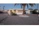 Single-story home boasting a covered parking, complemented by rock landscaping, and palm trees at 103 S 75Th Pl, Mesa, AZ 85208