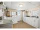 Functional laundry room with modern appliances, ample counter space, and storage cabinets at 103 S 75Th Pl, Mesa, AZ 85208