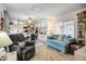 Comfortable living space with a cozy seating area, adjacent dining, and carpet flooring at 103 S 75Th Pl, Mesa, AZ 85208