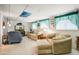 Spacious bonus room with comfortable seating, plush carpeting, and ample natural light, perfect for entertaining at 103 S 75Th Pl, Mesa, AZ 85208