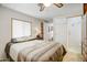 Relaxing bedroom with a comfortable bed, natural light, and en-suite bathroom at 103 S 75Th Pl, Mesa, AZ 85208